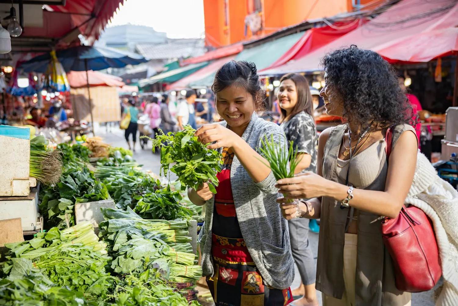 traveler at a bustling local market, interacting with a vendor
